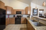 Fully equipped kitchen with cookware, flatware, and utensils 